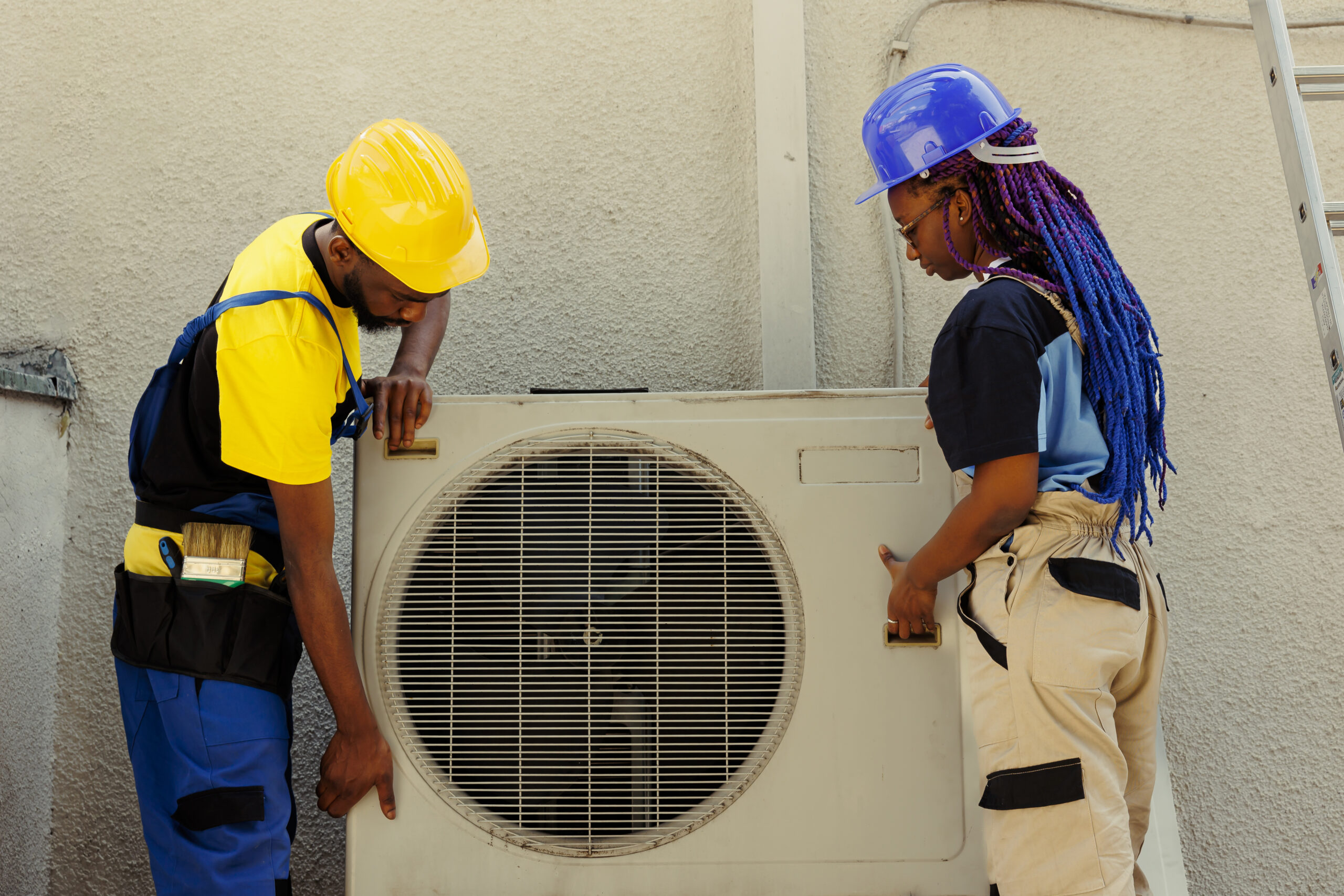 HVAC technician servicing an outdoor air conditioning condenser