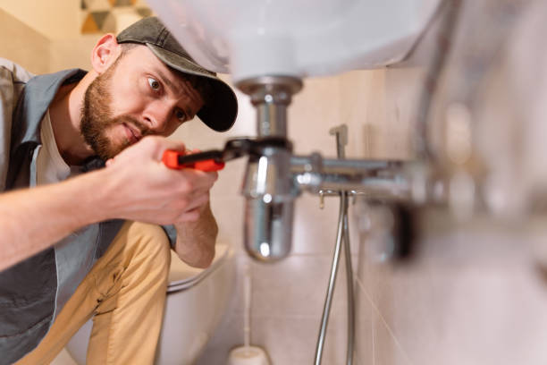 Plumber explaining a kitchen sink problem to a homeowner