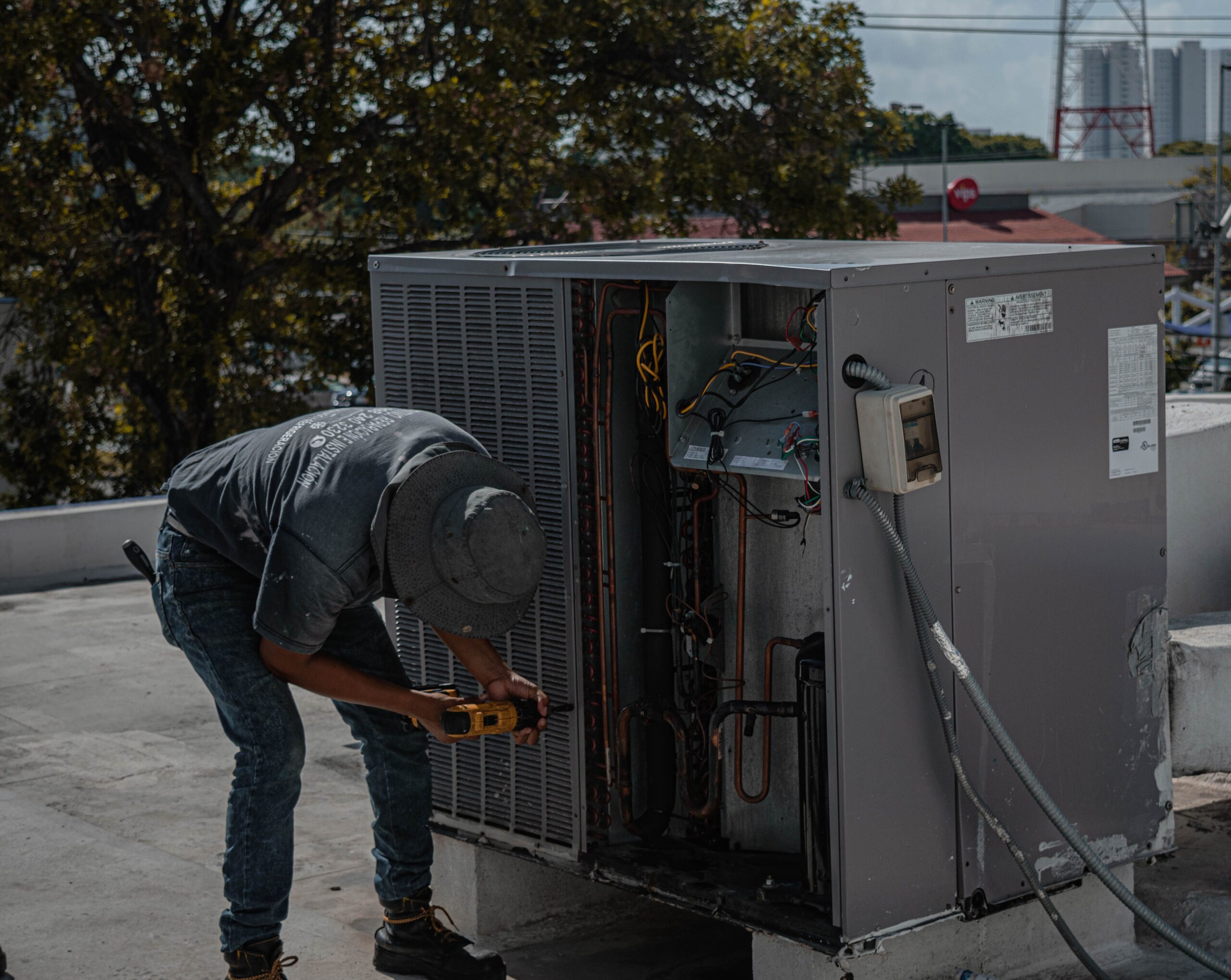 Technician inspecting HVAC equipment during a service visit